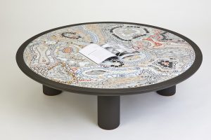 Mathilde Jonquière, mosaic artist, April 2023, original creation of a picassiette “Strates” table for Petit H, diameter 130cm. Godefroy de Virieu, Creative Director of Petit H, the Hermès re-creation workshop, commissioned Mathilde Jonquière to create a second low table in leather-covered picassiette © Eugenia Sierko