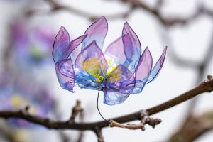 William Amor, upcycling artist, Creation of five sculptures “Métamorphoses arborescentes” made from plastic waste for Havas, Paris, December 2022. Floral ornaments made from recycled plastic, mounted on a varnished and resined plane tree branch, solid oak base, dimensions 185cm x 170cm